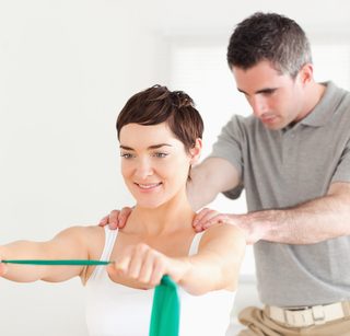 Woman working on exercise rehabilitation with chiropractor.