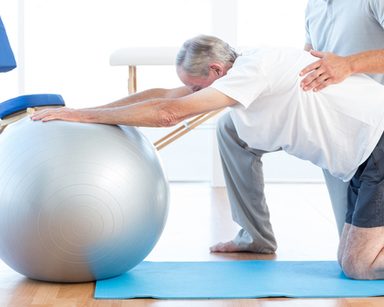 Man working on exercise rehabilitation with chiropractor.