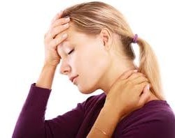 Woman holding forehead and neck in pain requiring remedial massage.